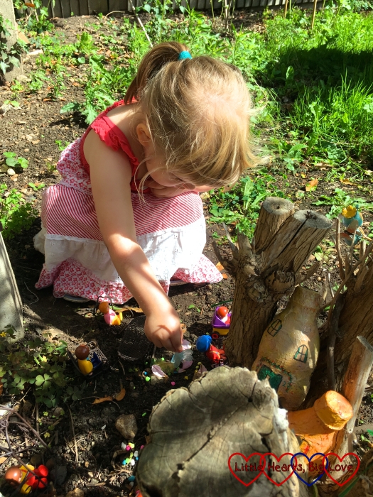 Sophie playing with the fairy garden at home