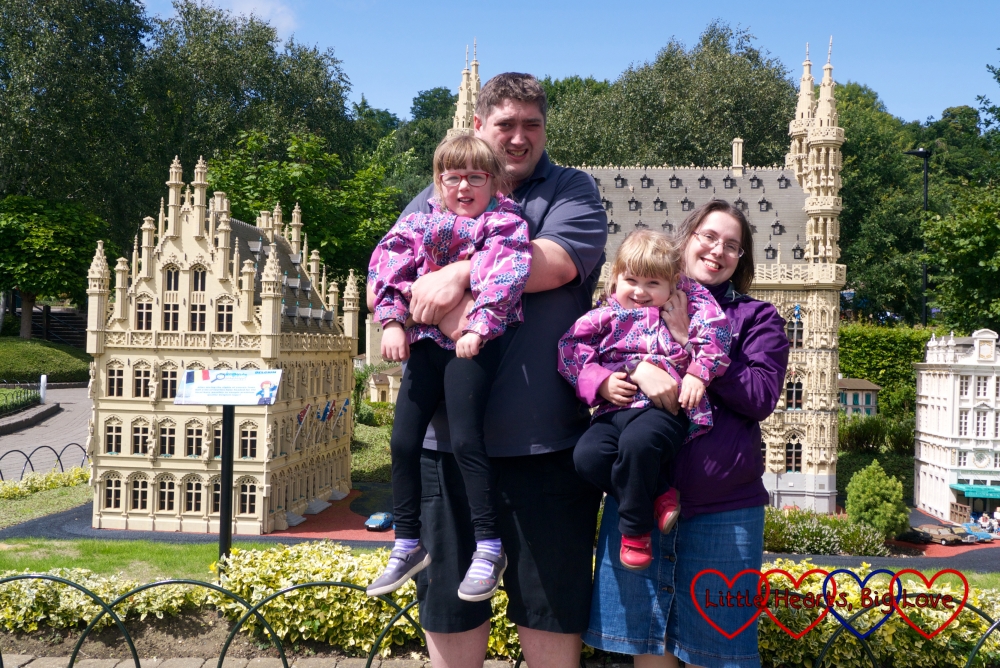 Me, hubby, Jessica and Sophie in front of a Lego building at Legoland