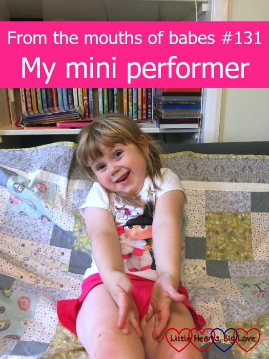 Sophie throwing out her arms in the middle of a performance on the sofa - "From the mouths of babes #131 - My mini performer"