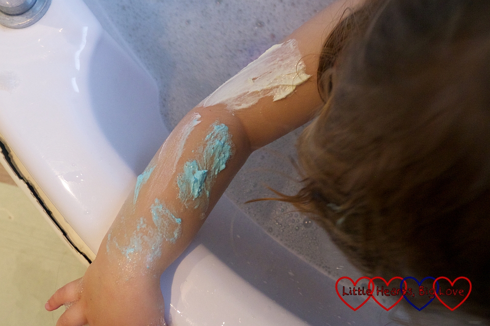 Jessica's arm covered in blue and pink soap paint