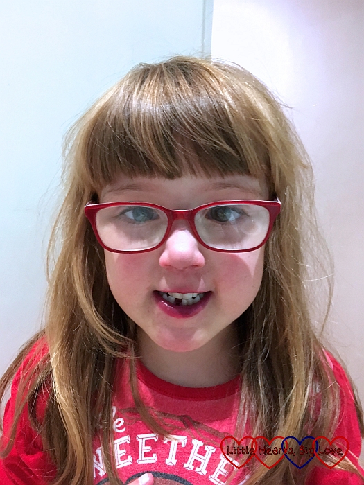 Jessica with a gappy grin after losing her first tooth