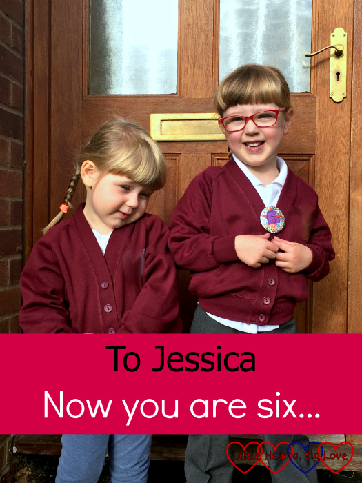 Jessica and Sophie standing in front of the front door in the school and preschool uniforms