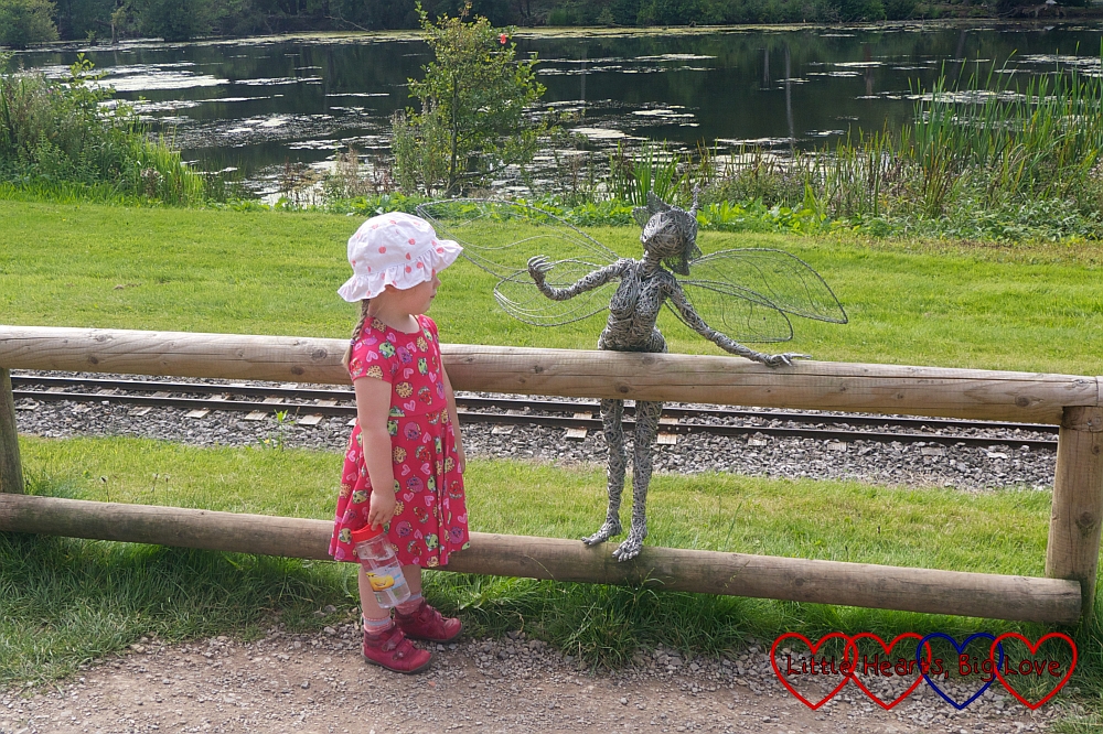 Sophie talking to one of the fairy sculptures at Trentham Gardens