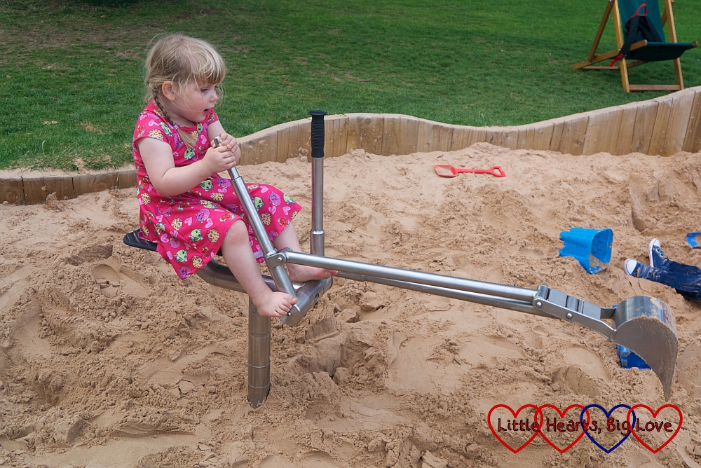 Sophie playing in the diggers in the sand area at Trentham Gardens