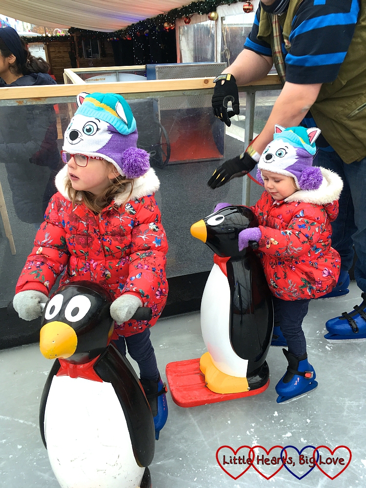 Jessica and Sophie holding on to penguin skate aids at the Windsor on Ice temporary ice rink