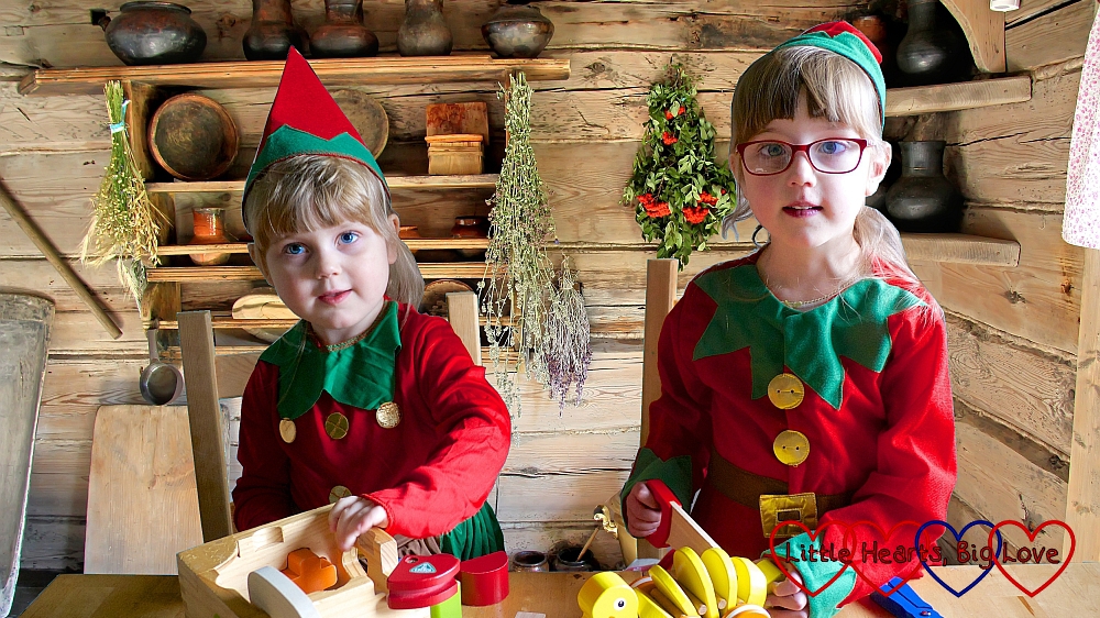 Jessica and Sophie dressed as elves "making" wooden toys