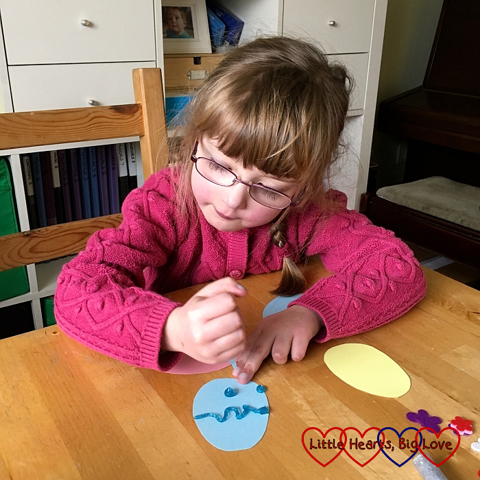 Jessica decorating a cardboard egg for Sophie's Easter egg crown