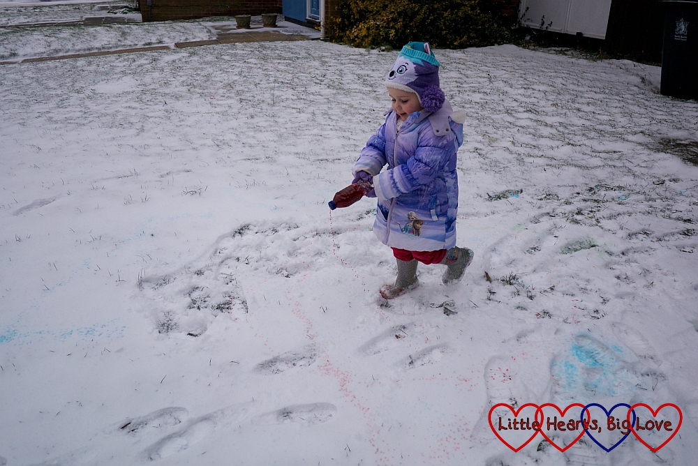 Sophie making "sprinkles" by spinning around with her "snow paint" bottle