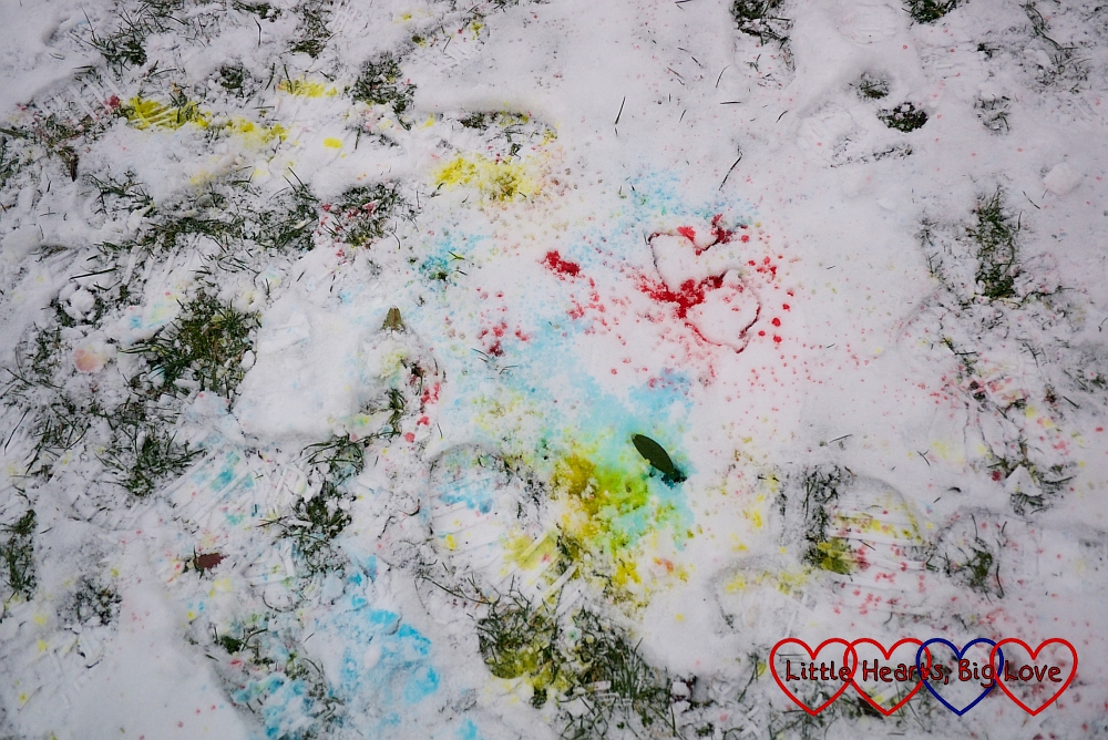 Red, yellow and blue coloured patches on the snow after some "snow painting"