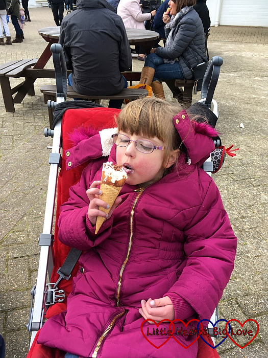 Jessica enjoying an ice cream while sitting in her buggy
