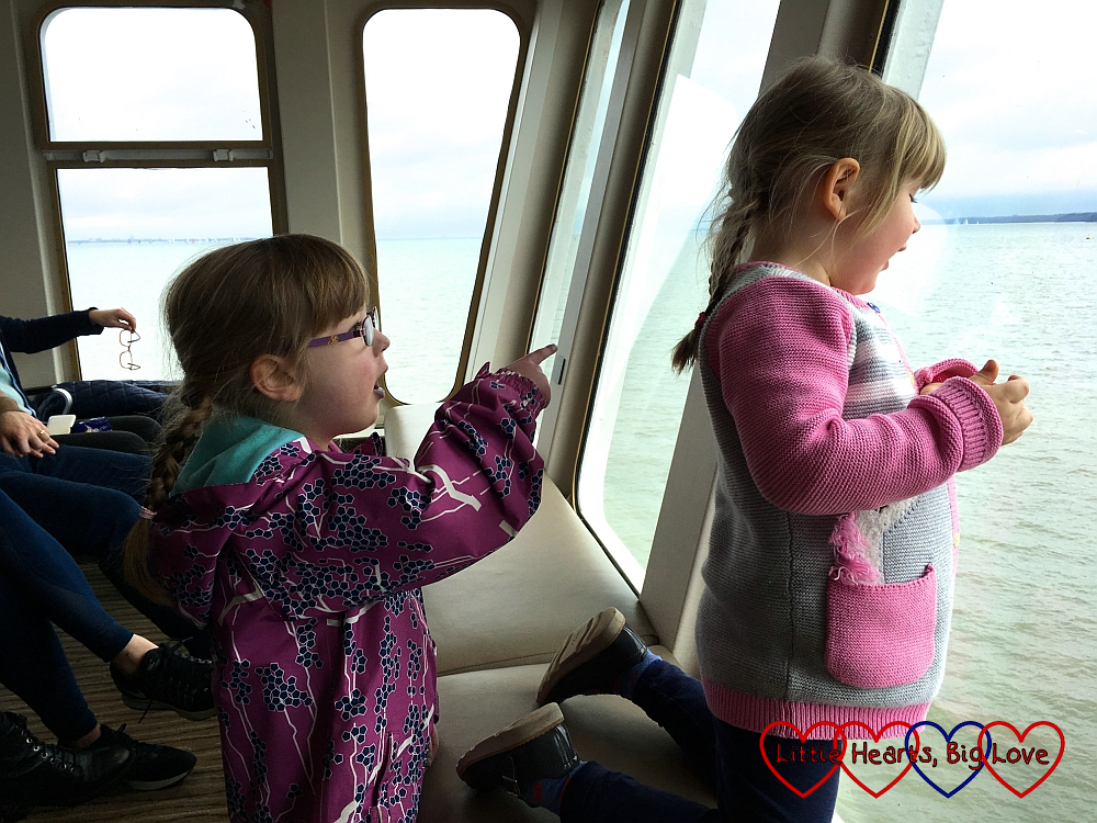 Jessica and Sophie looking out the window on the Isle of Wight ferry