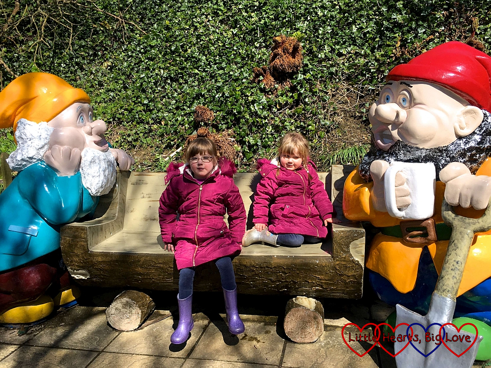 Jessica and Sophie sitting with the giant gnomes at Blackgang Chine