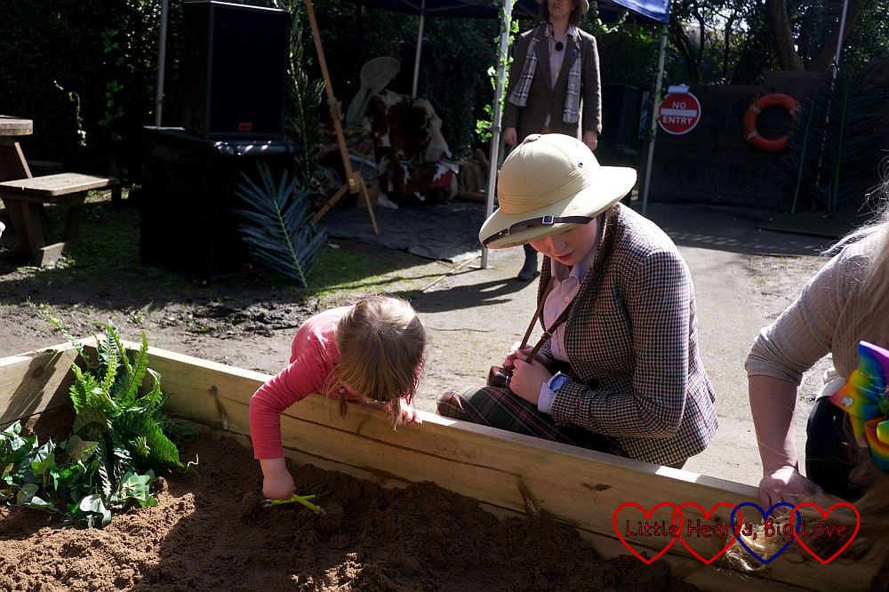 Sophie digging for fossils with one of the explorers