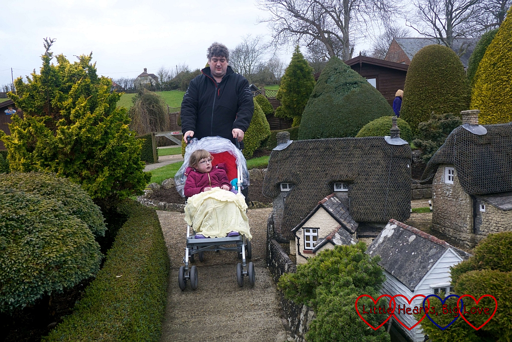 Hubby pushing Jessica in her buggy around Godshill Model Village