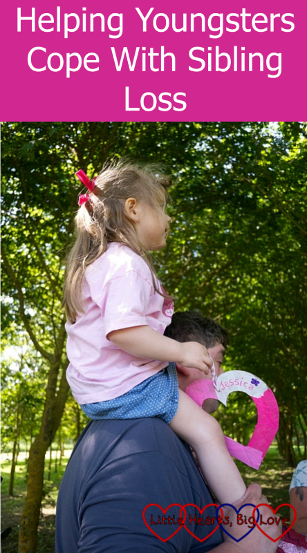 Sophie on Daddy's shoulders getting ready to hang Jessica's heart on the memorial tree - "Helping youngsters cope with sibling loss"