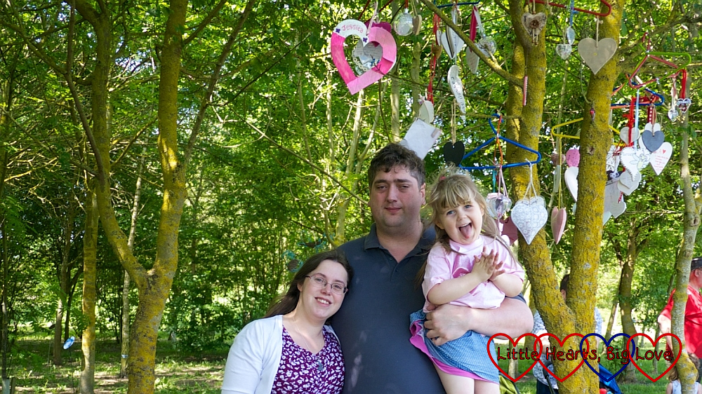 Me, hubby and Sophie at the National Memorial Arboreteum underneath the heart we hung for Jessica in the tree