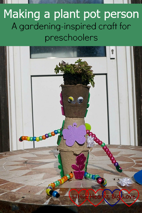 A pot plant person made from three cardboard pots with a plant in the top one - "Making a plant pot person - A gardening-inspired craft for preschoolers"