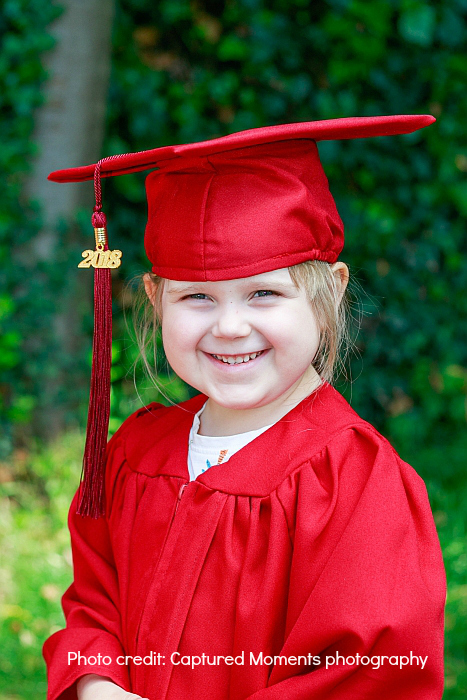 Sophie in her preschool graduation robe
