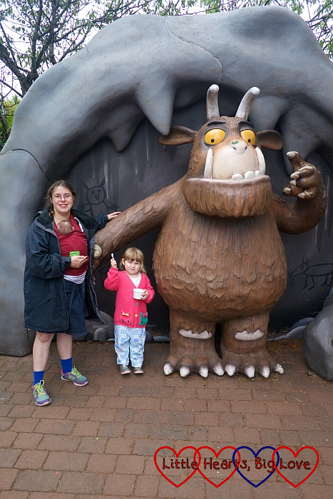 Sophie, Mummy and Thomas posing with a statue of the Gruffalo