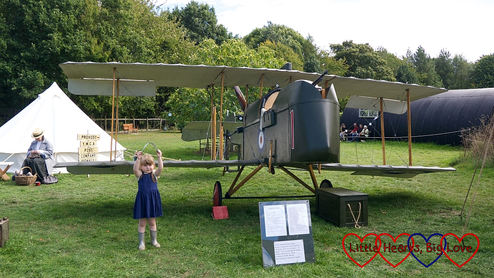 Sophie standing next to a WW1 plane