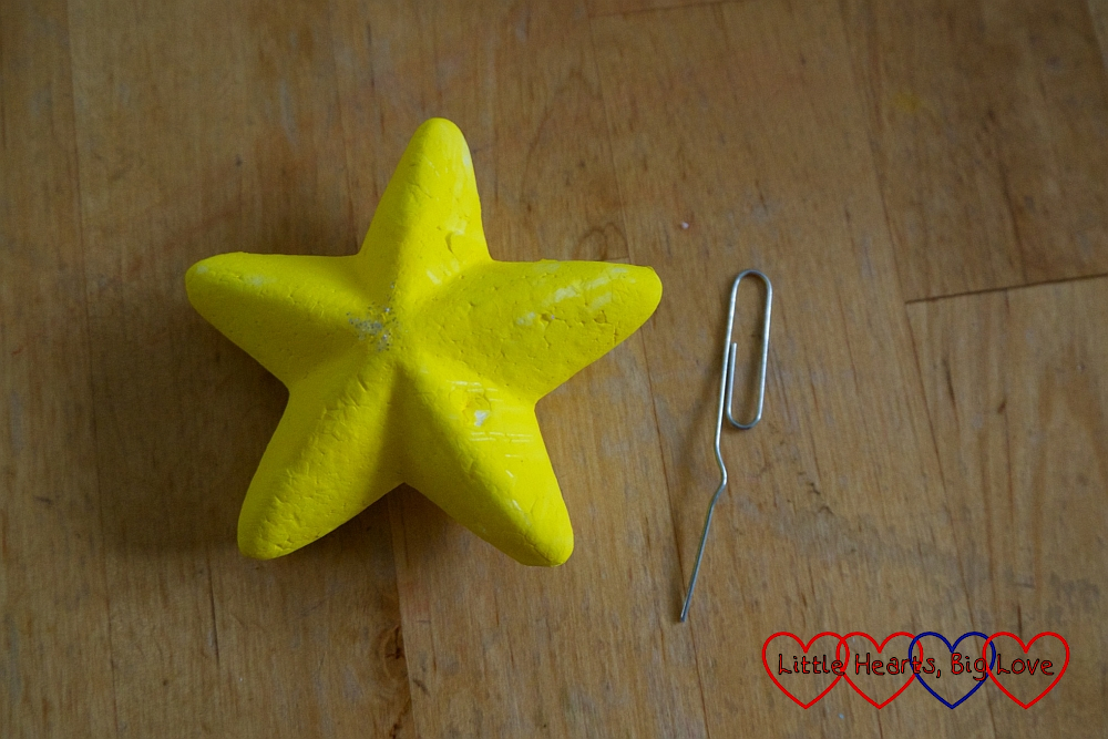 A polystyrene star with a paperclip next to it with one end unbent