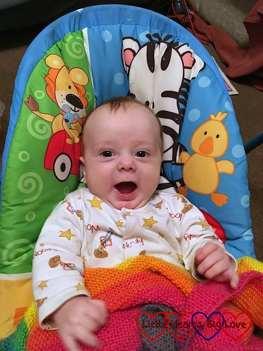 A smiley Thomas sitting in his swing