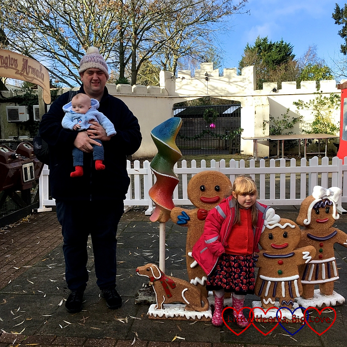 Hubby, Thomas and Sophie next to gingerbread figures outside the Gruffalo's Kitchen