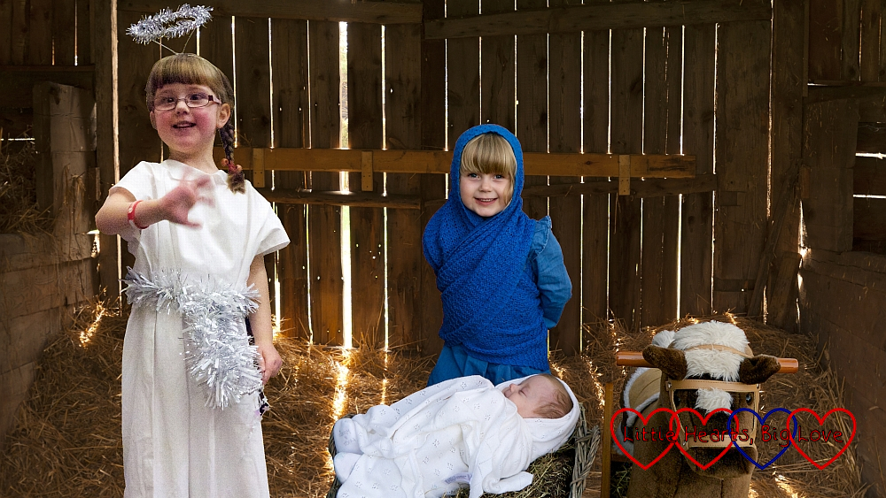 A Nativity scene with Sophie as Mary, Thomas as baby Jesus and Jessica as an angel