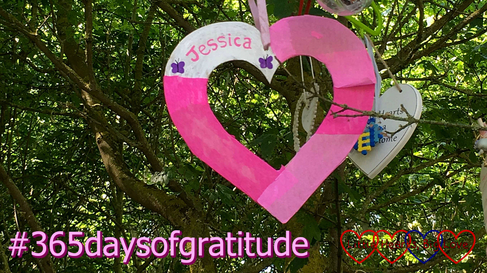 A paper heart with "Jessica" on it hanging from a tree and #365daysofgratitude