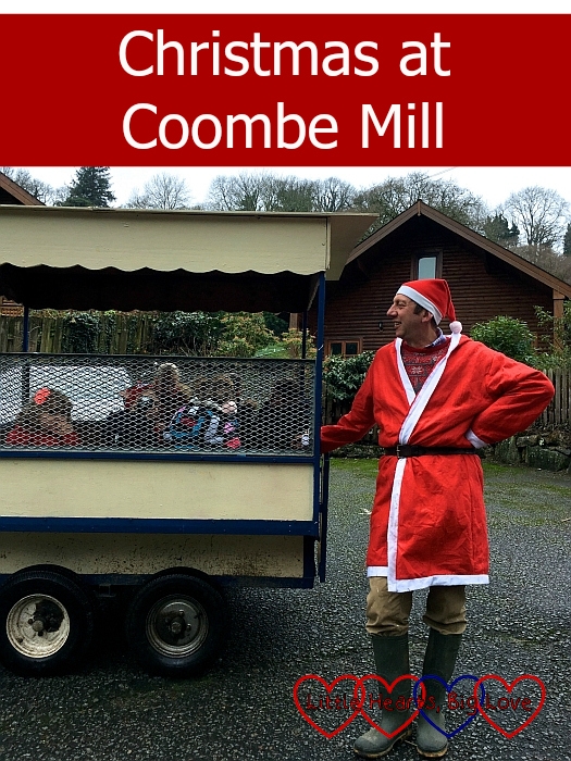 Farmer Christmas standing next to the children's trailer - "Christmas at Coombe Mill"