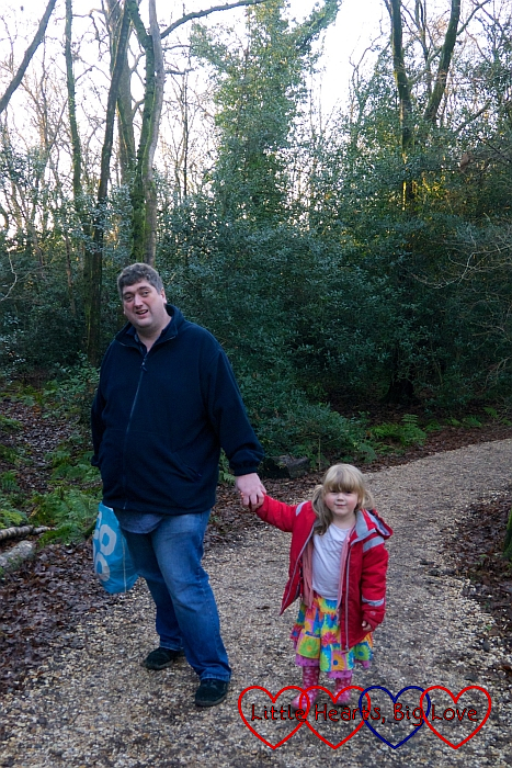 Sophie and Daddy walking through the woods