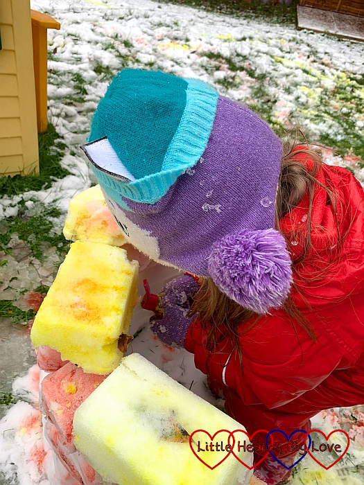 Sophie squirting coloured water on her igloo