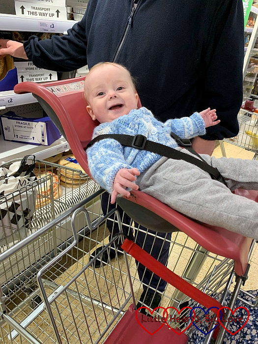 Thomas enjoying a ride in the supermarket trolley