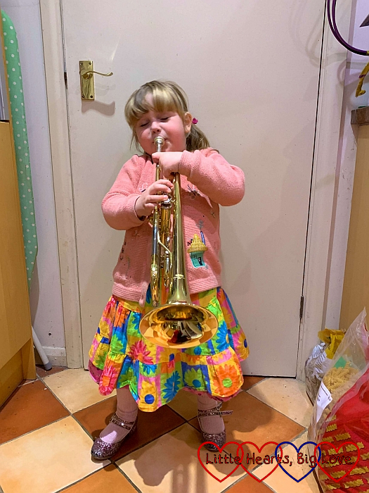 Sophie playing Daddy's trumpet
