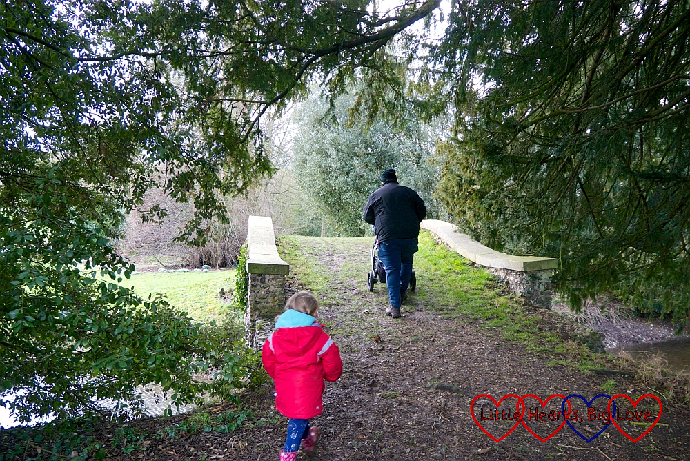 Hubby and Sophie heading over a bridge at West Wycombe Park
