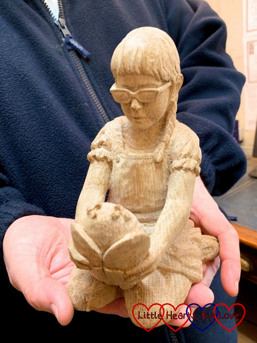 The untreated carving of Jessica holding Kerry with Jessica facing the camera