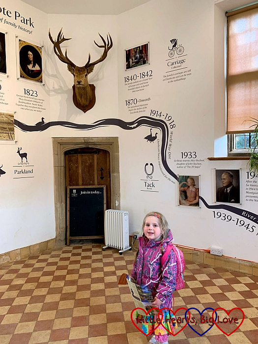 Sophie inside the gate house where the walls are illustrated with the family history of the Lucy family who own Charlecote.