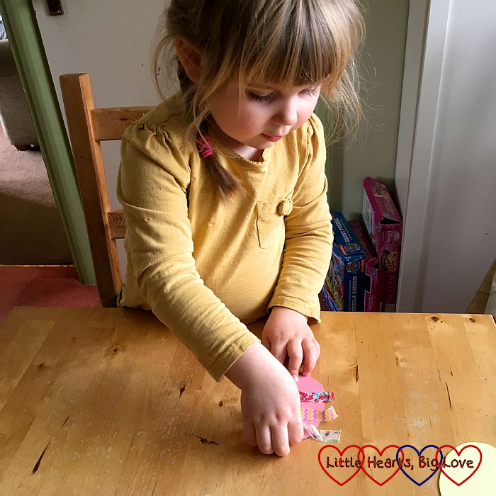 Sophie using washi tape to decorate her egg shapes