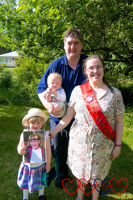 Me wearing a 40th birthday sash, Sophie holding a picture of Jessica and hubby holding Thomas at my 40th birthday barbecue