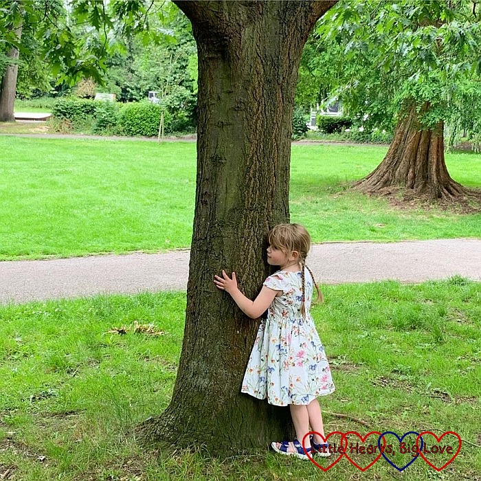 Sophie hugging a tree
