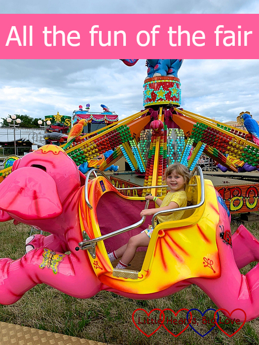 Sophie in a pink elephant on the Flying Jumbos ride - "All the fun of the fair"