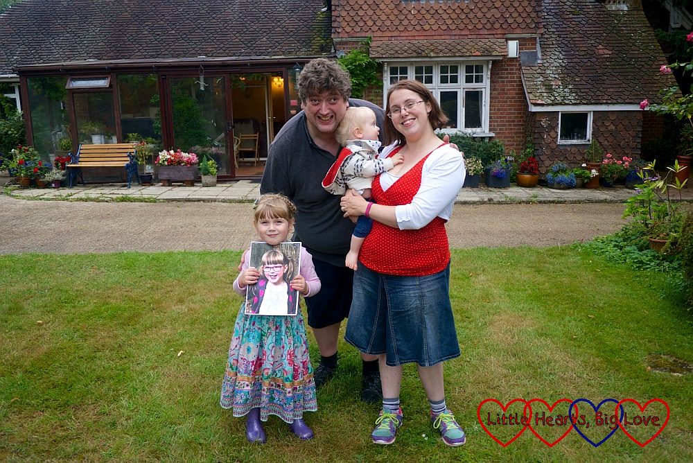 Me (holding Thomas), hubby and Sophie (holding Jessica's picture) in Grandma and Grandad's garden at Thomas's birthday party