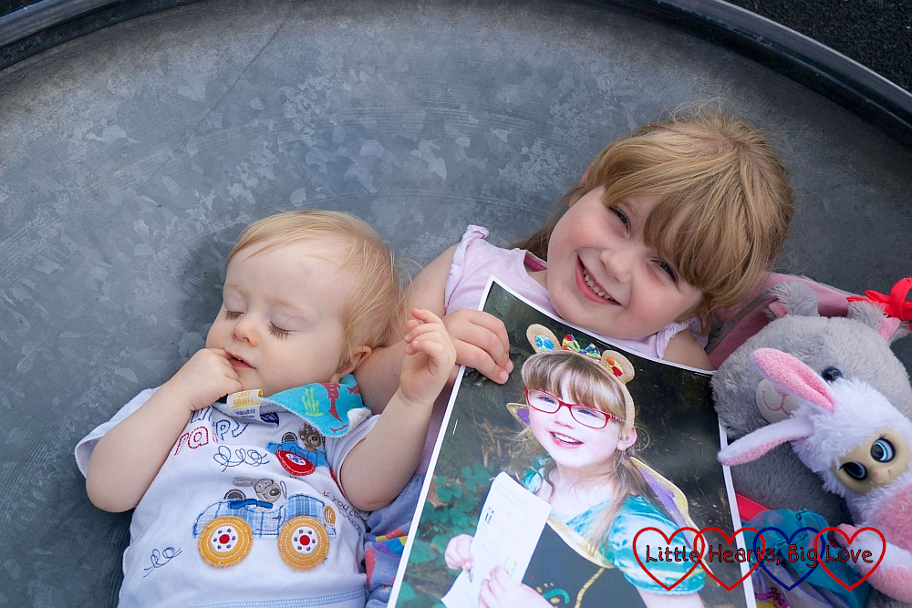 Thomas and Sophie holding a picture of Jessica in a spinning saucer