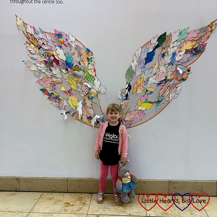 Sophie standing in front of the Halo wings with her Jessica bunny