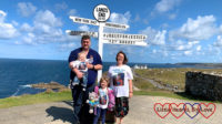 Me, hubby, Sophie and Thomas wearing our "JoGLE for Jessica" T-shirts at the Land's End signpost with "JoGLE for Jessica 12th August" added to the signpost