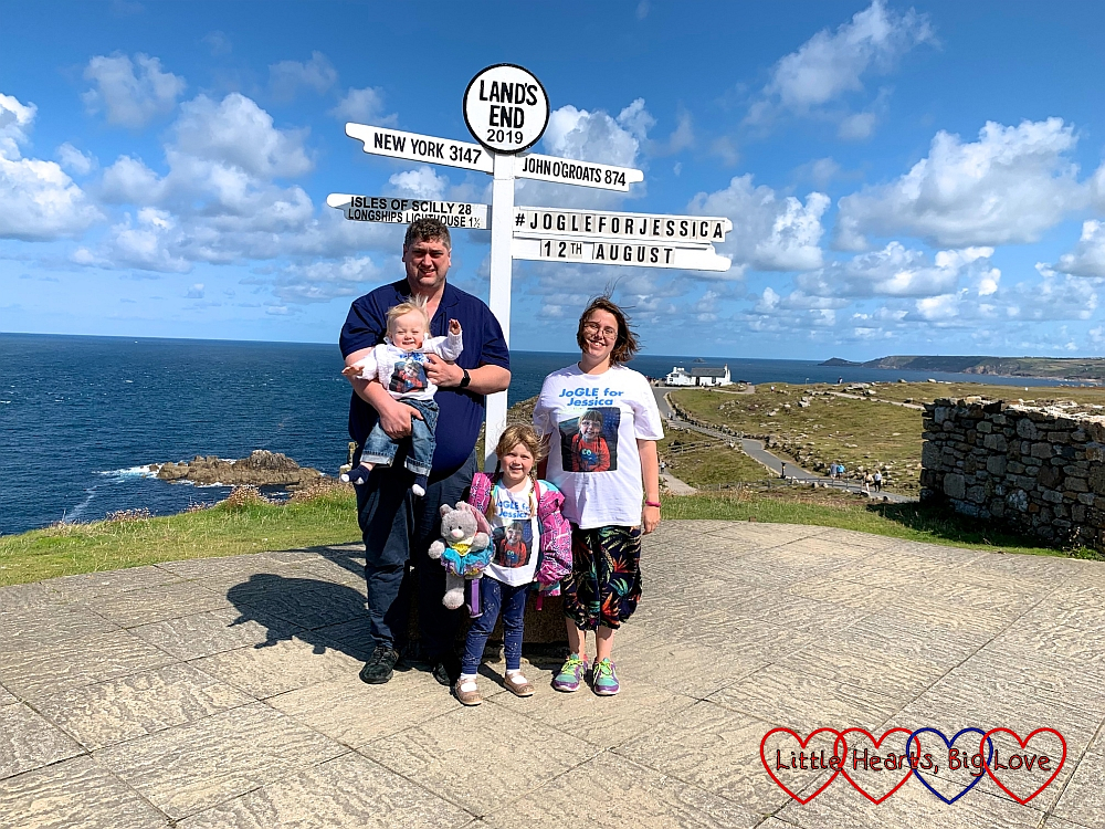 Me, hubby, Sophie and Thomas wearing our "JoGLE for Jessica" T-shirts at the Land's End signpost with "JoGLE for Jessica 12th August" added to the signpost