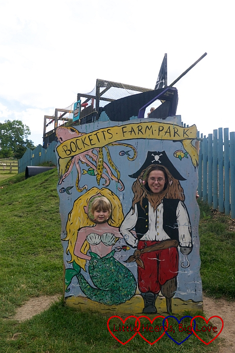 Me and Sophie with our heads through the picture board showing us as a pirate and mermaid with “Bocketts Farm Park” written above our heads