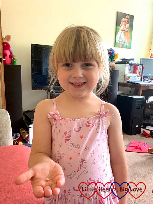 Sophie holding her first lost tooth in her hand