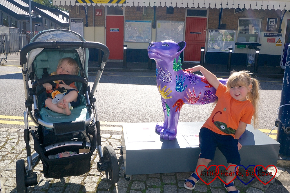 Thomas and Sophie with 'Roary' - a purple lion covered in glittery handprints - one of the lions on the Lions of Windsor trail