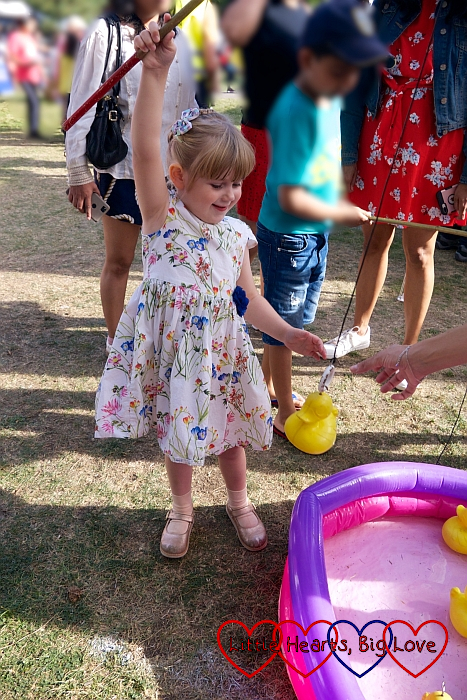 Sophie hooking a duck from an inflatable paddling pool